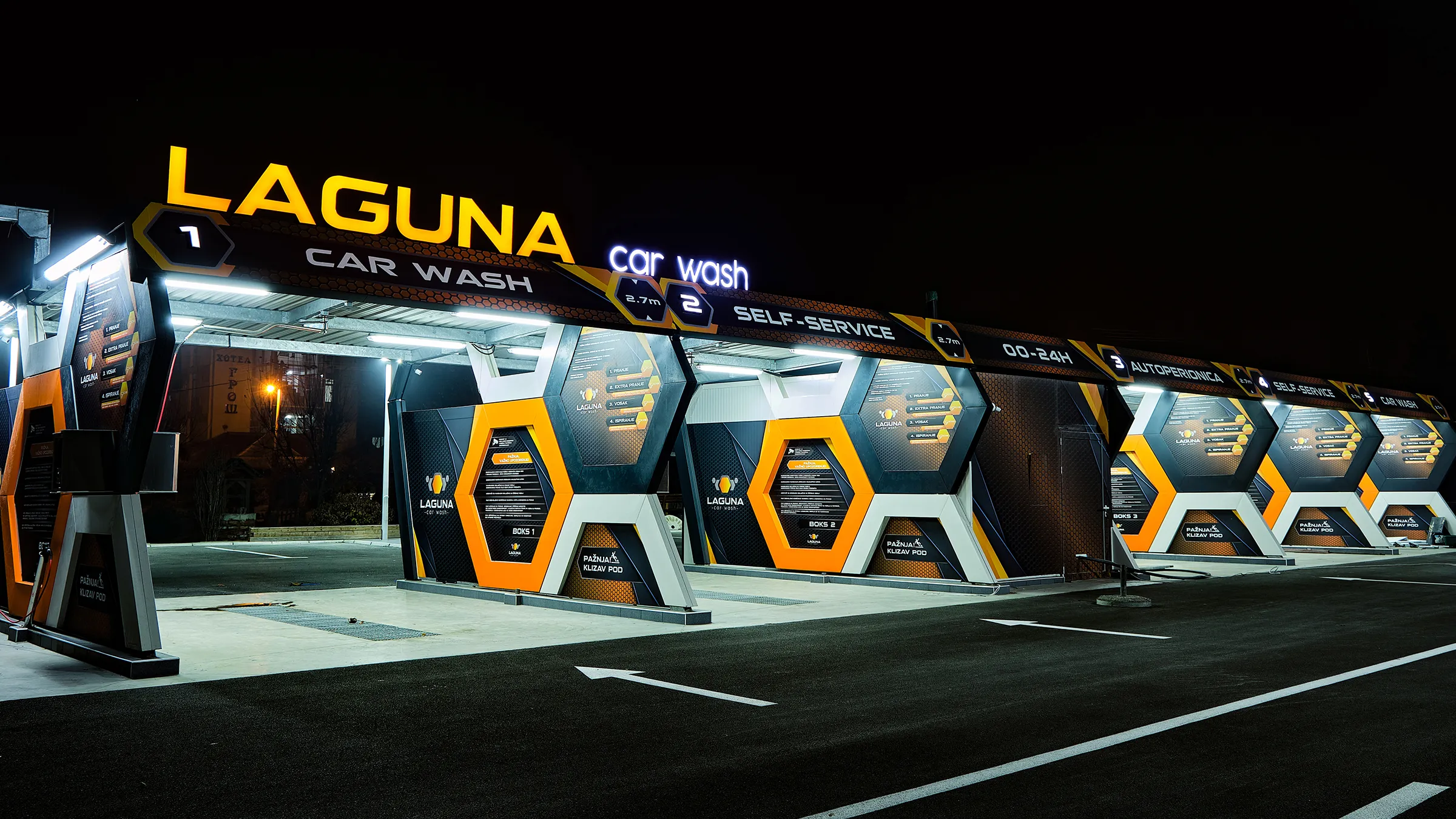 Laguna Car Wash - exterior signage and hexagonal brand identity photographed at night